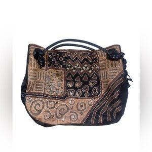 Black and brown Chico's boho leather handbag with magnetic closure